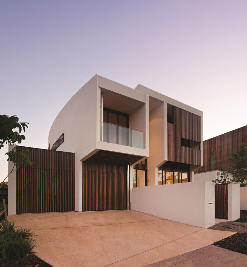 18 Inspirational Examples Of Modern Garage Doors // Thin wood slats conceal these garage doors and match the rest of the modern exterior.