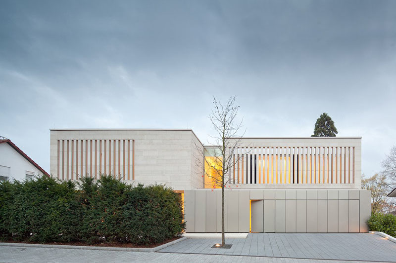 18 Inspirational Examples Of Modern Garage Doors // The garage doors of this home blend into the rest of the bottom layer, and create a contemporary look with their vertical lines.