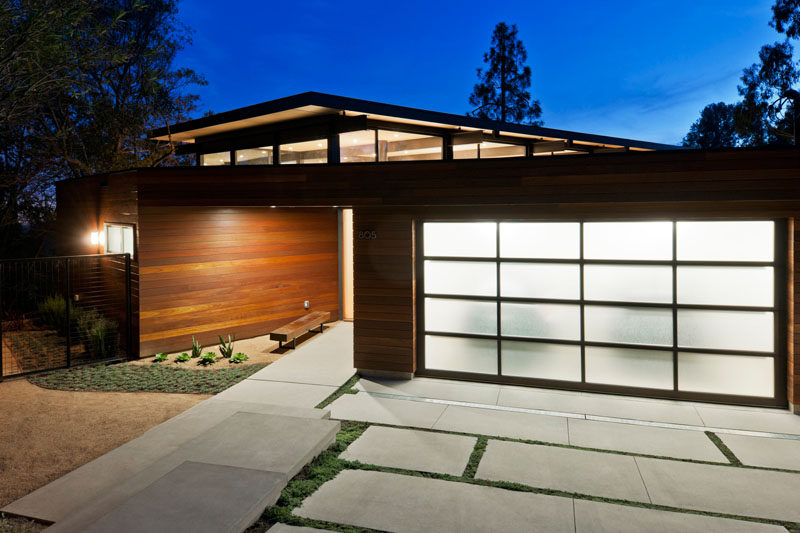 18 Inspirational Examples Of Modern Garage Doors // Frosted glass panels provide privacy and brighten the exterior when lit from the inside.