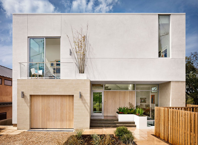 18 Inspirational Examples Of Modern Garage Doors // The light wood on this garage door matches the color of the bricks around it and the front door, creating a cohesive front exterior.