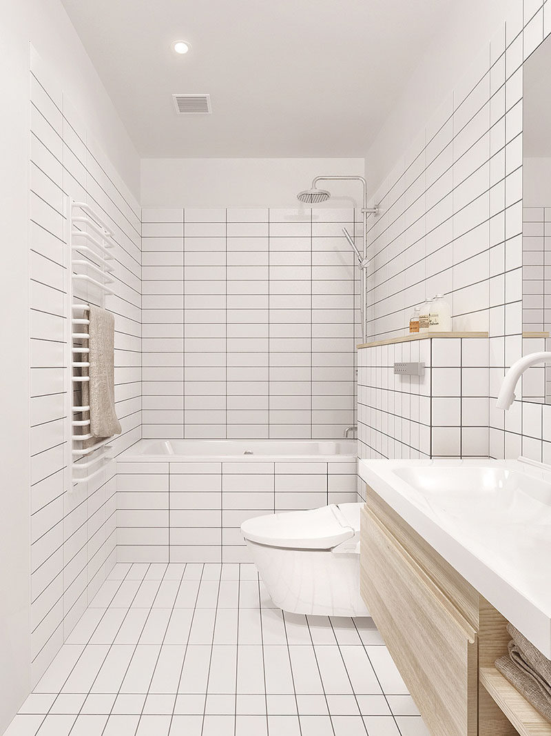 8 Examples Of Tile Flooring With Geometric Patterns // The floor of this bathroom is covered in clean white rectangular tiles mixed with a single line of square tiles to add a touch of interest.