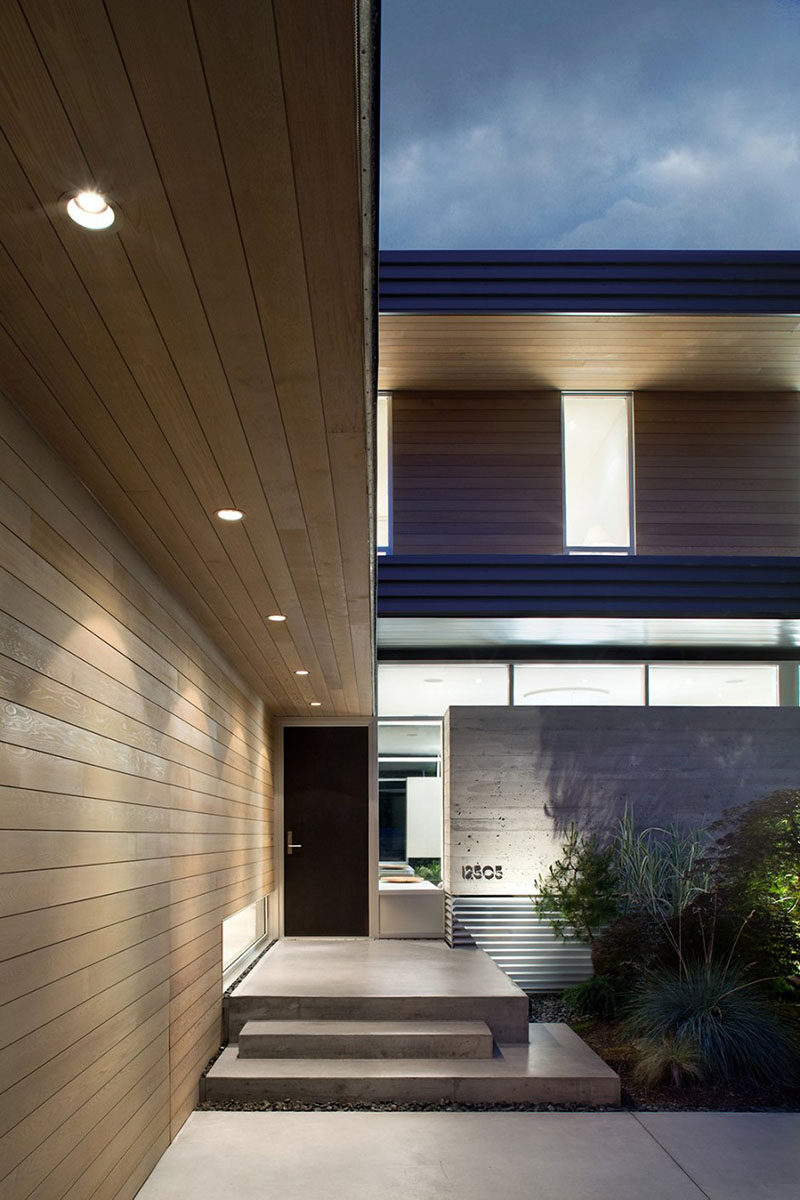  Down-lighting and concrete steps lead you to the front door of this home.