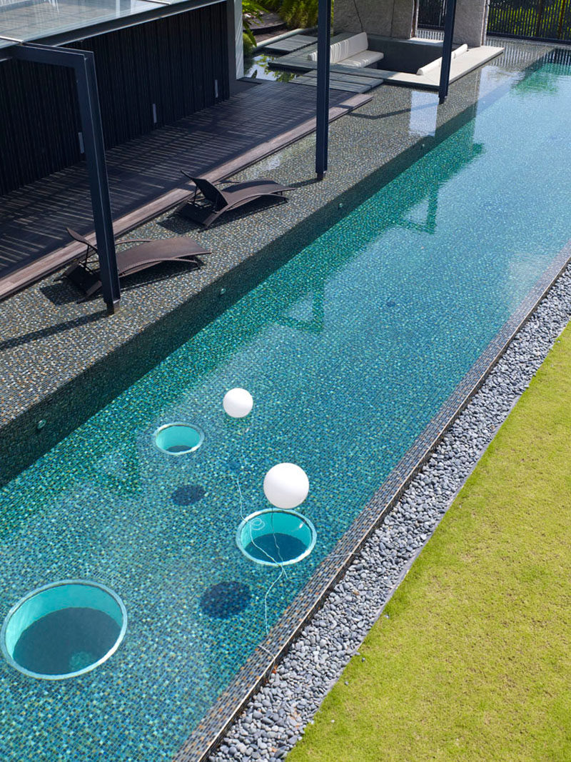 This swimming pool has windows at the bottom to see through to the level below.