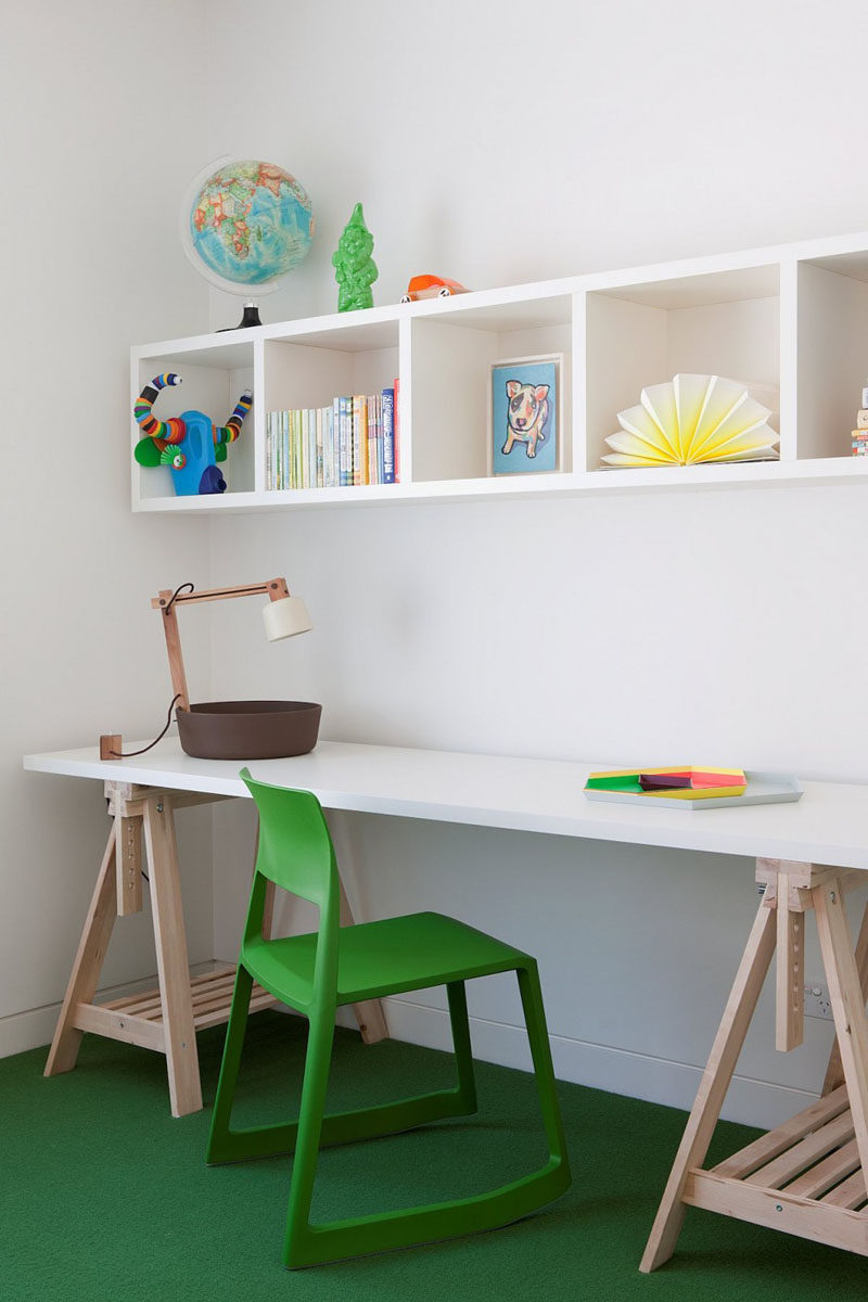 This children's homework station is a simple green and white colour palette with touches of light wood.