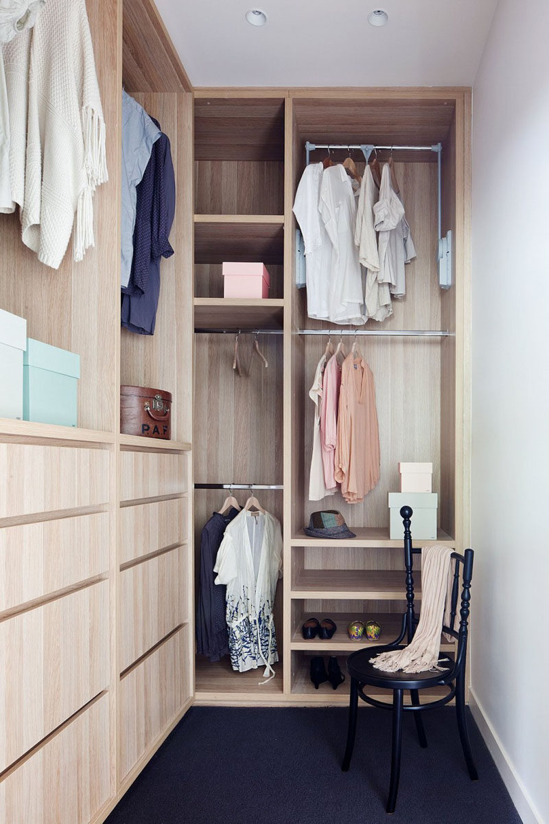 This small, light wood, walk-in closet has floor-to-ceiling mixed storage.