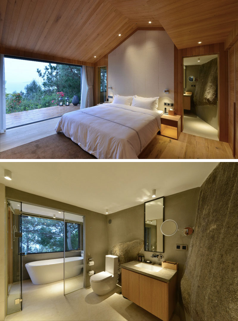 This hotel room in China has a large natural rock feature in the bathroom, and a deck next to the bed provides amazing views of the forest in Xiamen