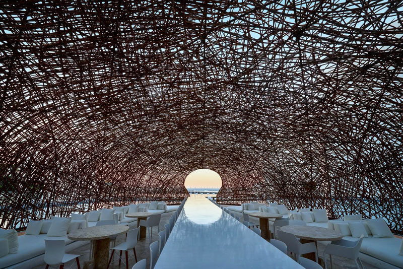 Surrounded entirely by water, made from thin strips of wood and seeming to float right on its surface is Restaurant Nido; one of the three world class restaurants at Mar Adentro Hotel, a five-star hotel designed by Miguel Ángel Aragonés in San José del Cabo, Mexico.