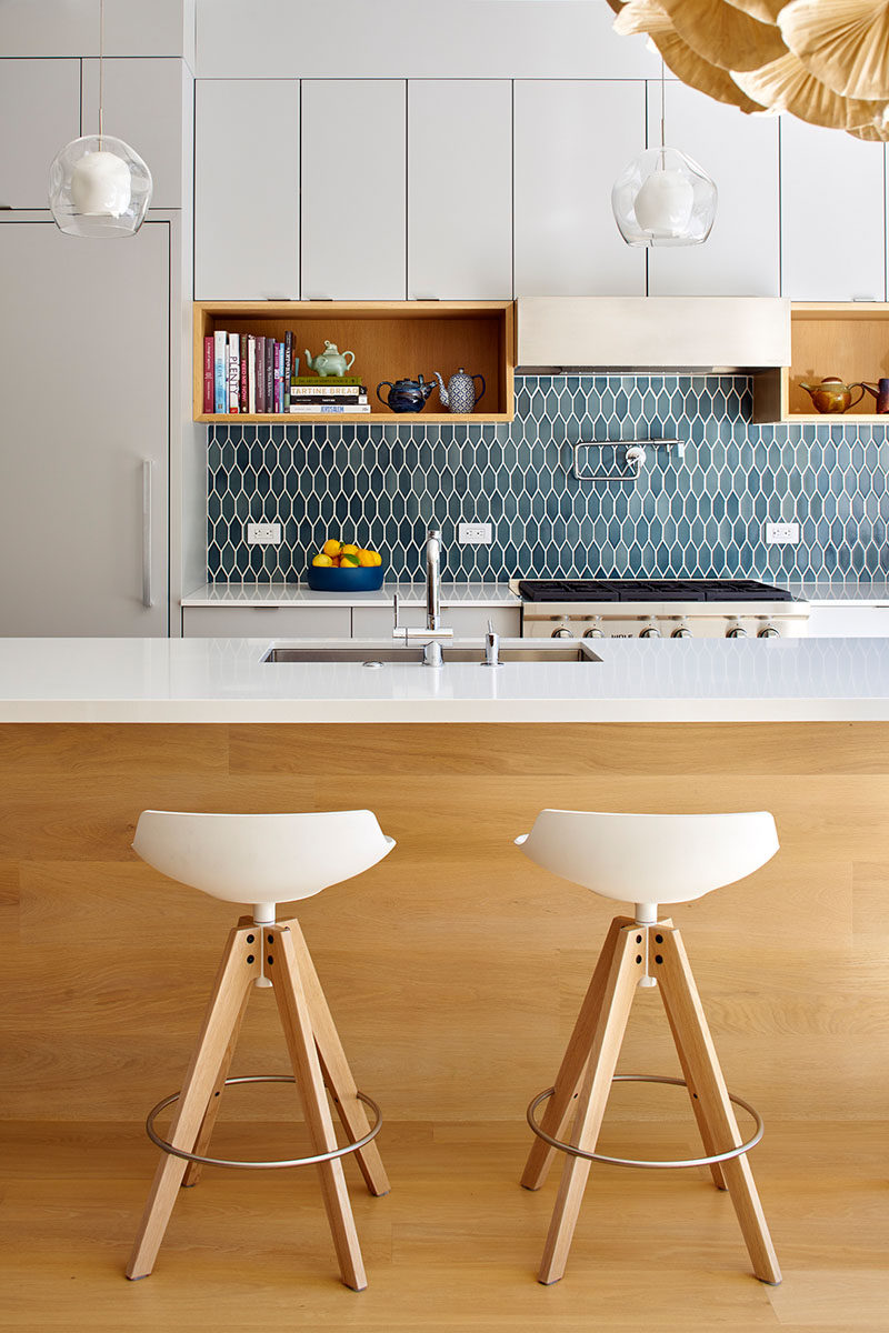 9 Inspirational Pictures Of Kitchens With Geometric Tiles // The blue hexagon tiles have been elongated to give the backsplash of this bright kitchen a unique touch.
