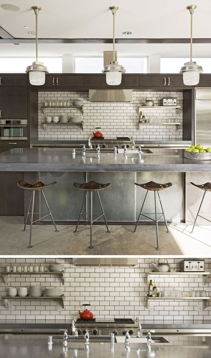 9 Inspirational Pictures Of Kitchens With Geometric Tiles // The dark grout used to fill the spaces between the white subway tiles match the other dark elements in the kitchen, like the cabinetry and bar stools.