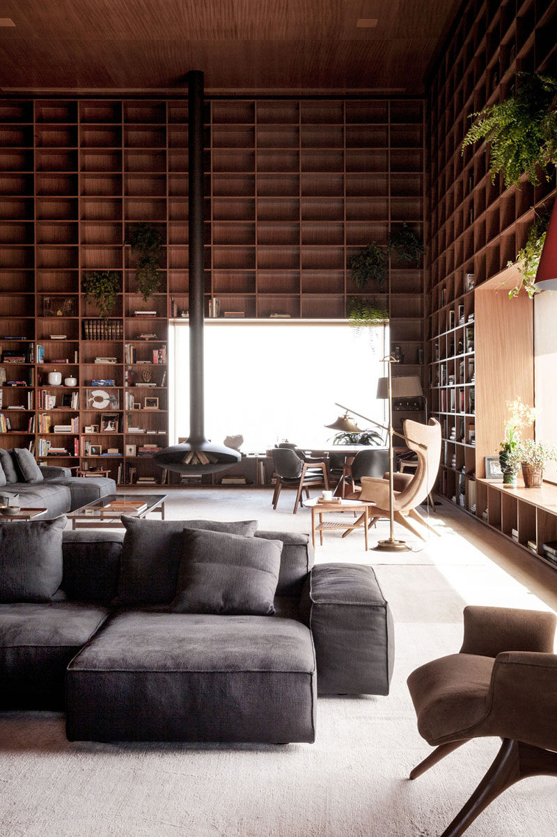 A double height room with floor-to-ceiling wooden shelves