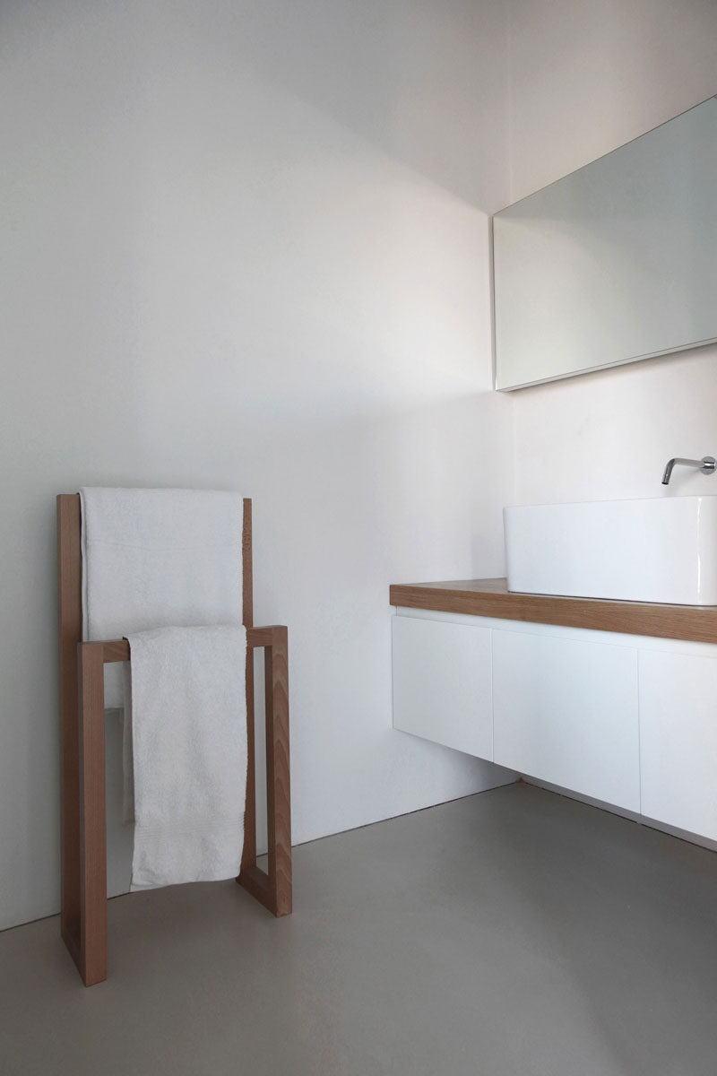 6 Ideas For Creating A Minimalist Bathroom // Stick To Simple Materials --- Adding touches of wood or concrete to offset an all white bathroom adds texture and warmth to the bathroom while keeping a simple aesthetic.