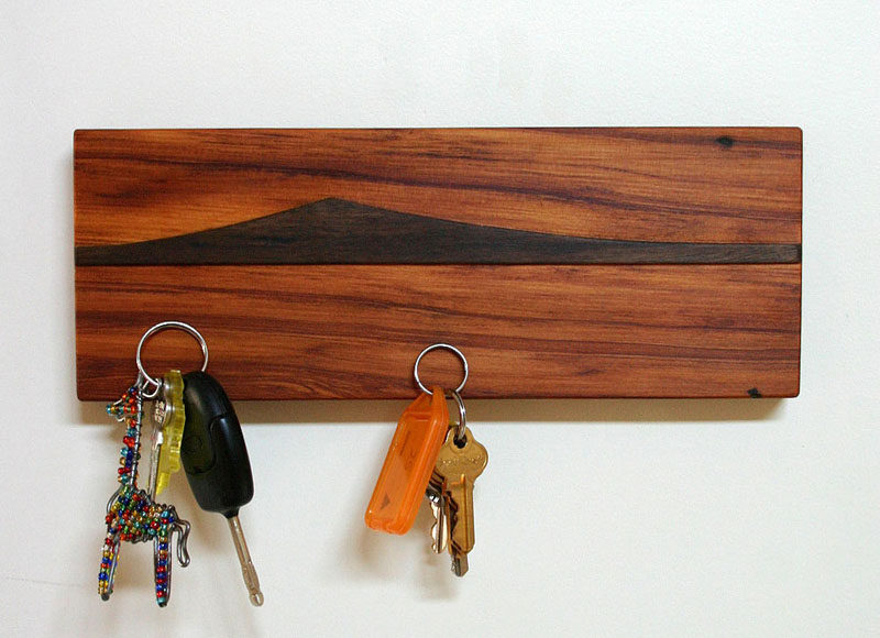 16 Key Holders To Keep You Organized // Add a small piece of artwork to your wall with this magnetic wooden key holder featuring an island view from New Zealand.