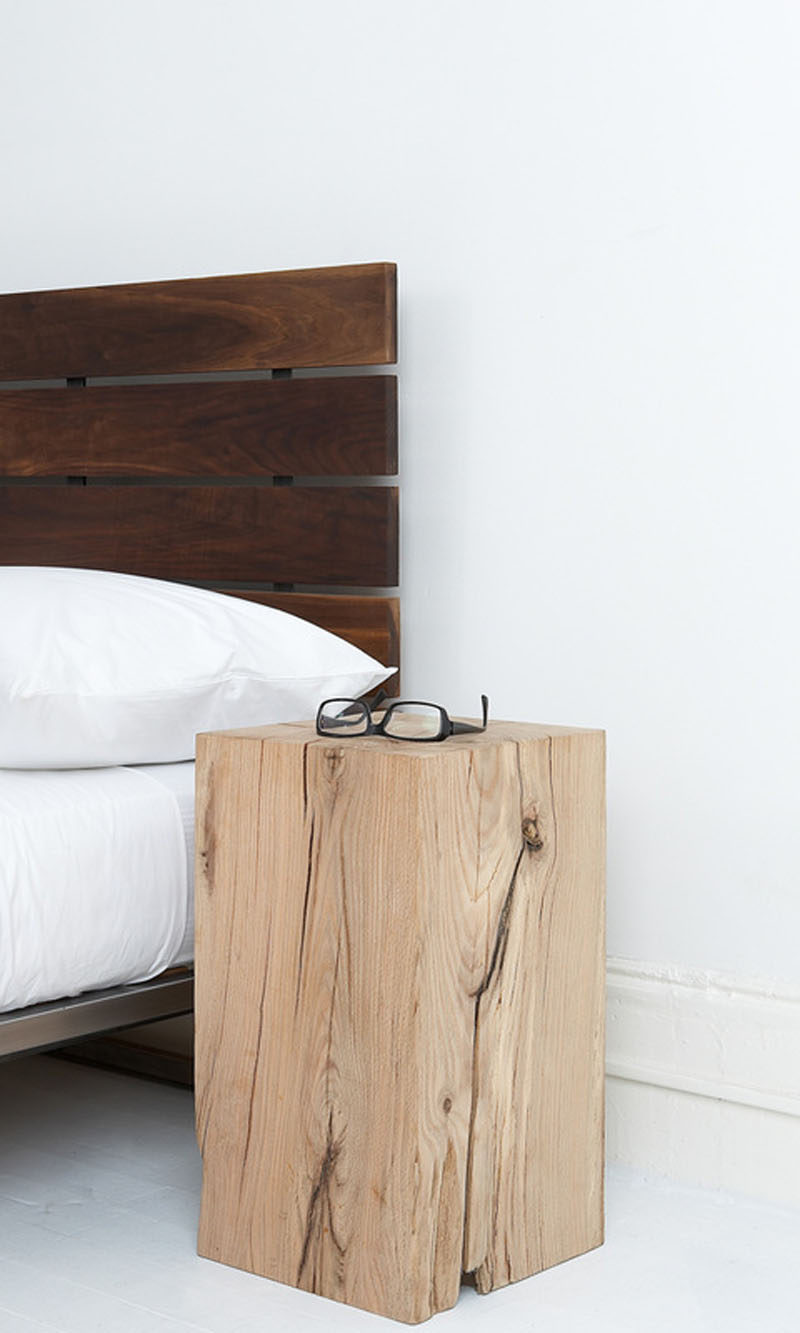 9 Different Ideas For Adding A Nightstand To Your Bedroom // Add A Touch Of Nature --- Use tree stumps or a block of raw wood for a rustic yet modern nightstand.