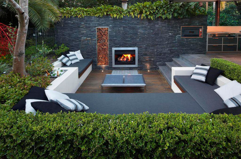 15 Outdoor Conversation Pits Built For Entertaining // Complete with a built in fireplace, wood storage, and a cooler, this sunken conversation pit would be great for both social gatherings and quite afternoons tucked up with books. #ConversationPit #FirePit #YardIdeas