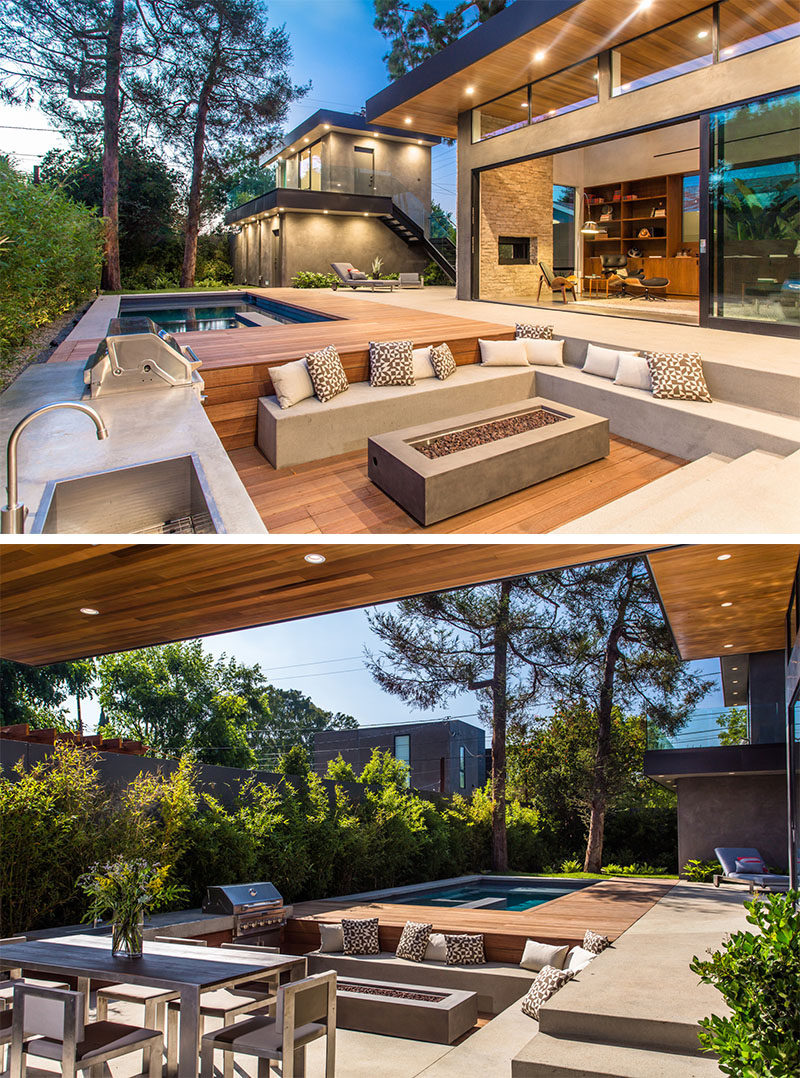 15 Outdoor Conversation Pits Built For Entertaining // This sunken conversation pit tucked right into the deck has a fire pit, bbq and kitchen area, allowing entertaining and and cooking to take place in the same spot. #ConversationPit #FirePit #YardIdeas