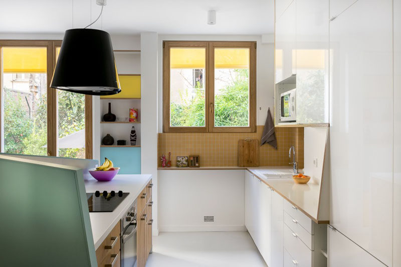 This small kitchen is partially closed off from the dining and living room by an angled pony wall.