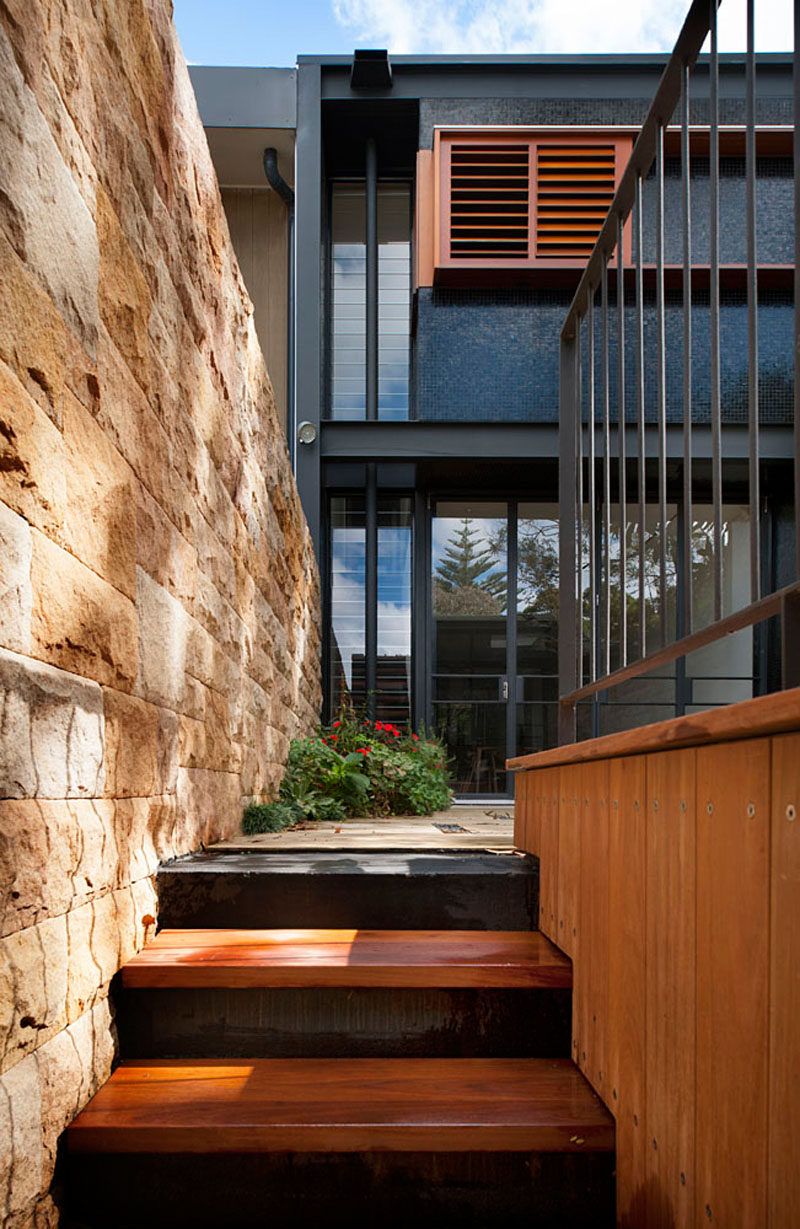 Sandstone walls have been paired with wood and black details to give this terrace home an updated look.