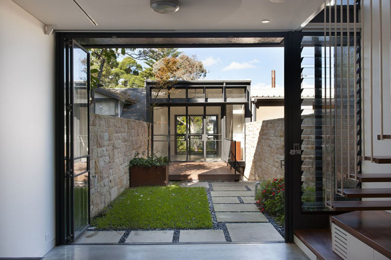 A small grassy area separates two different spaces in this home.