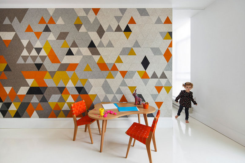 Multi-colored triangular pieces of felt add color to this accent wall that separate the child's bedroom from the rest of the home.