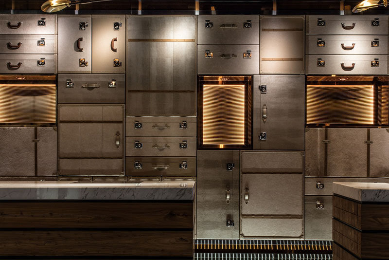 The accent wall behind the check-in area of this hotel is made of luggage cases in all different positions to create depth and intrigue.