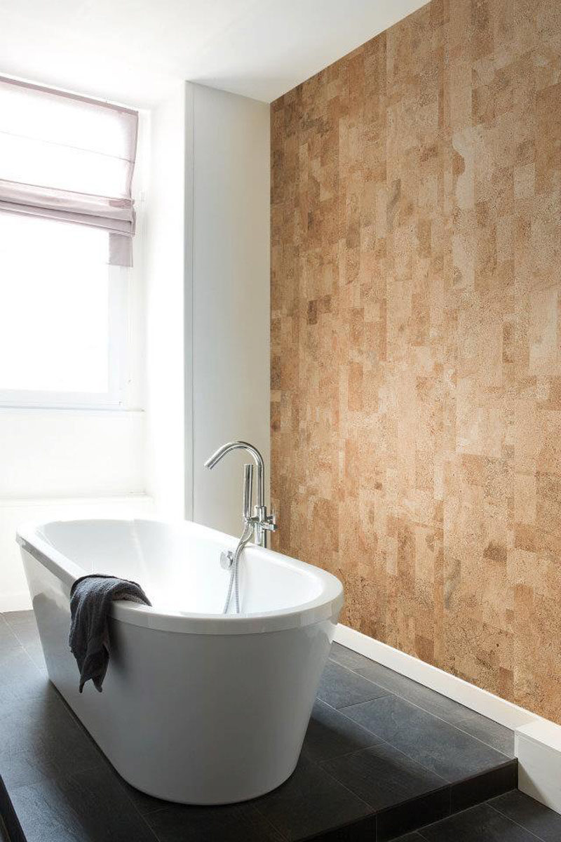 Cork panels have been used to create a natural accent wall in a bathroom.