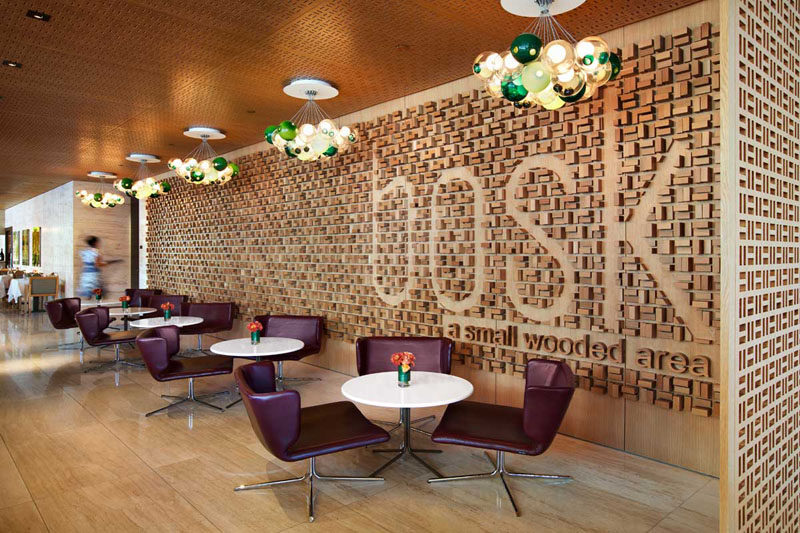 Accent Wall Ideas - 12 Different Ways To Cover Your Walls In Wood // Wood blocks have been arranged on this wall to create a textured look and spell out the name of the restaurant in an original way.  #AccentWall #FeatureWall #WoodAccentWall #WoodFeatureWall #InteriorDesign