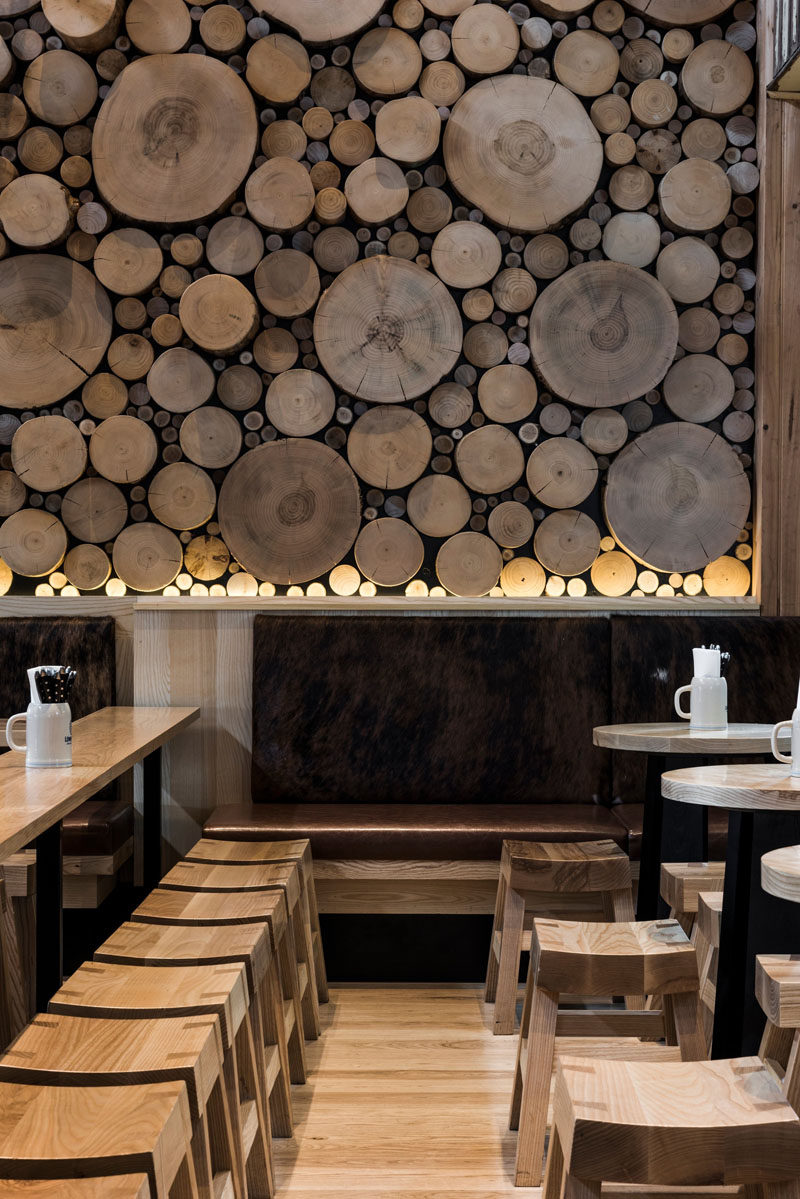 Accent Wall Ideas - 12 Different Ways To Cover Your Walls In Wood // The cross sections of tree stumps displayed on this wall bring in warmth and mimic the natural look of a forest floor.  #AccentWall #FeatureWall #WoodAccentWall #WoodFeatureWall #InteriorDesign