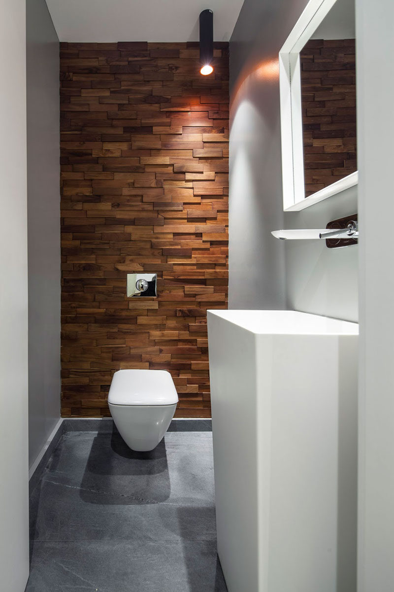 Accent Wall Ideas - 12 Different Ways To Cover Your Walls In Wood // Thin wood blocks running up this wall soften the industrial feel created by the concrete floor and warm up the white bathroom elements.  #AccentWall #FeatureWall #WoodAccentWall #WoodFeatureWall #InteriorDesign