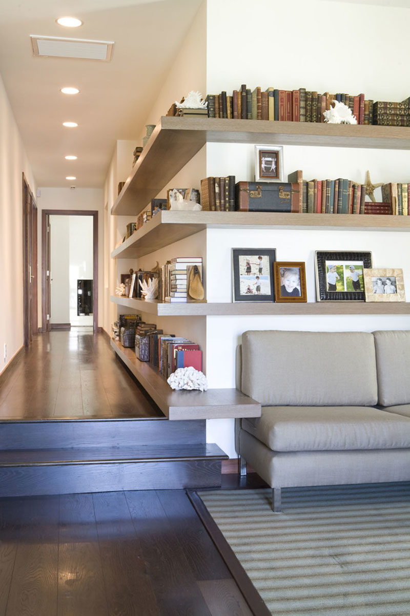 SHELVING IDEA - Shelves That Wrap Around Corners // These shelves run part way down the hallway, wrap around the corner, and continue into the living room, allowing the decor to seamlessly flow from one space to the next