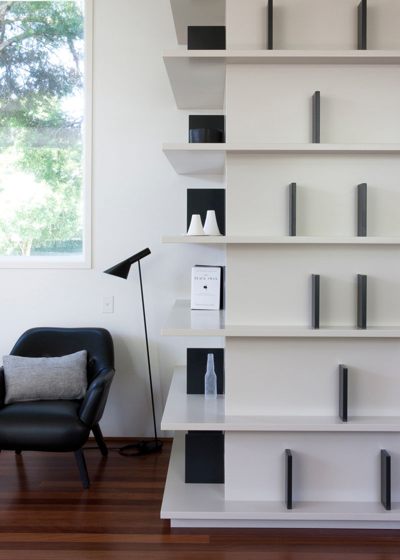 SHELVING IDEA - Shelves That Wrap Around Corners // White shelves with dividers built in meet at the corners and make it easy to grab your favorite book on your way to your reading spot.