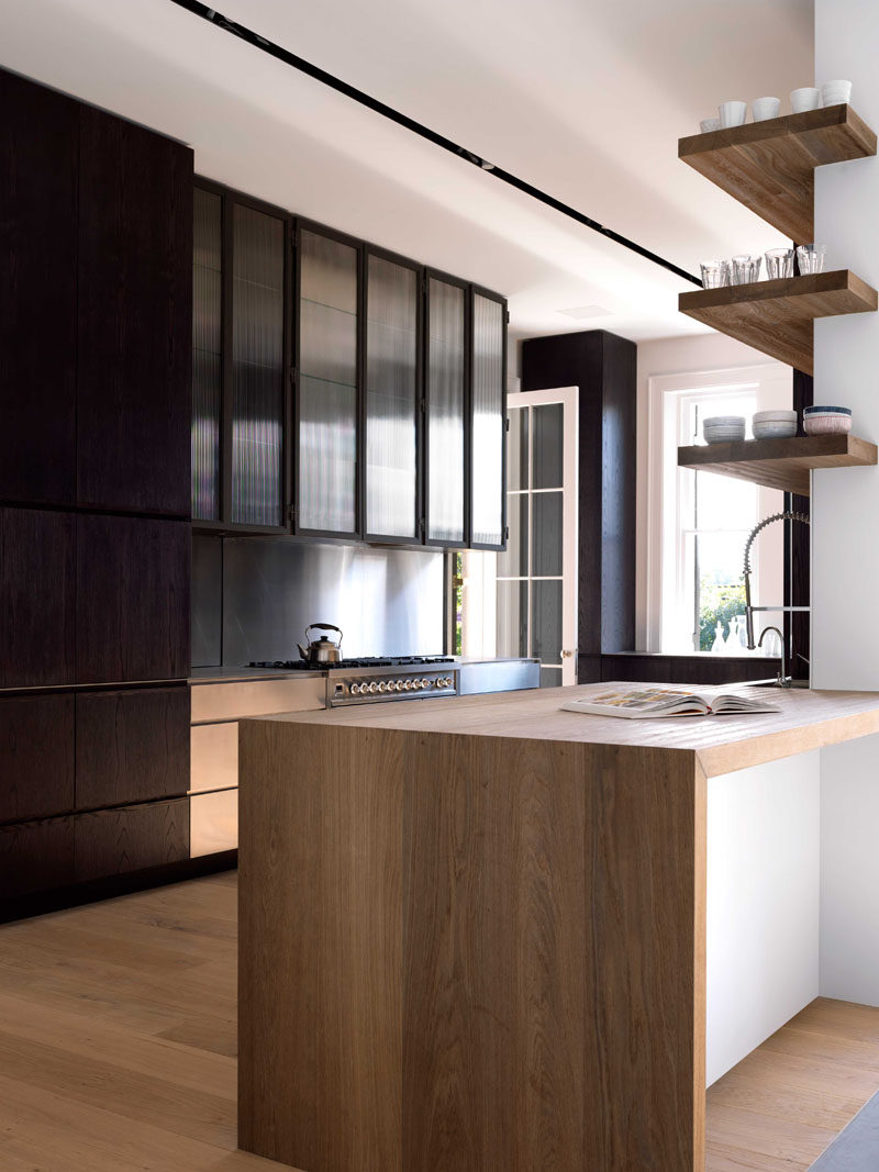 SHELVING IDEA - Shelves That Wrap Around Corners // These shelves wrapped around the partial wall in this kitchen are a unique take on the open shelving trend.