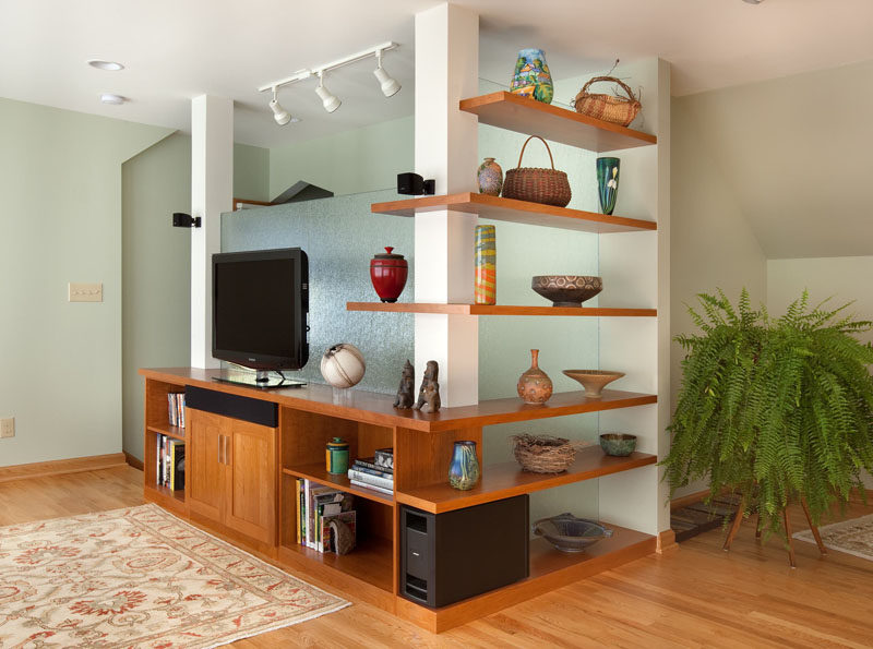 SHELVING IDEA - Shelves That Wrap Around Corners // Wrap around shelves in this entertainment area provide space to display treasures and favorite possessions.