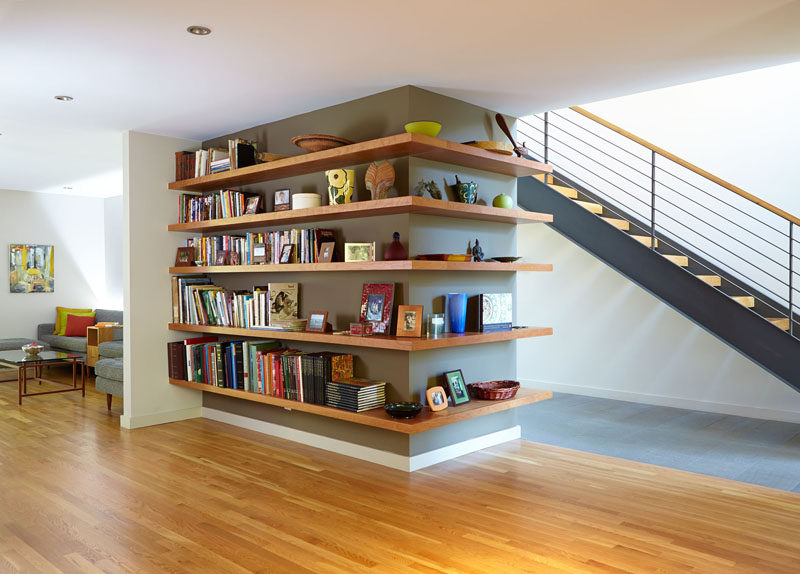 SHELVING IDEA - Shelves That Wrap Around Corners // Books have been confined to one side while decor pieces are displayed on the other side of this wrap around shelving installation.