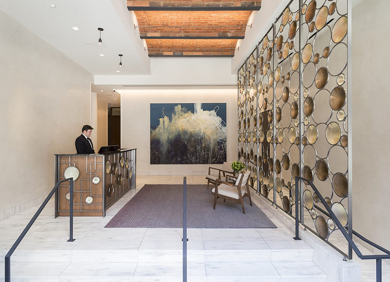 Room Divider Idea - Artist Christophe Côme created a 'Bubble Screen', made from iron, industrial crystal and molded glass lenses, that is art and also functions as a room divider in the lobby of a New York building.