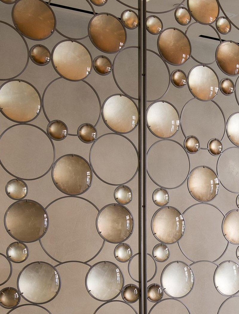 Room Divider Idea - Artist Christophe Côme created a 'Bubble Screen', made from iron, industrial crystal and molded glass lenses, that is art and also functions as a room divider in the lobby of a New York building.