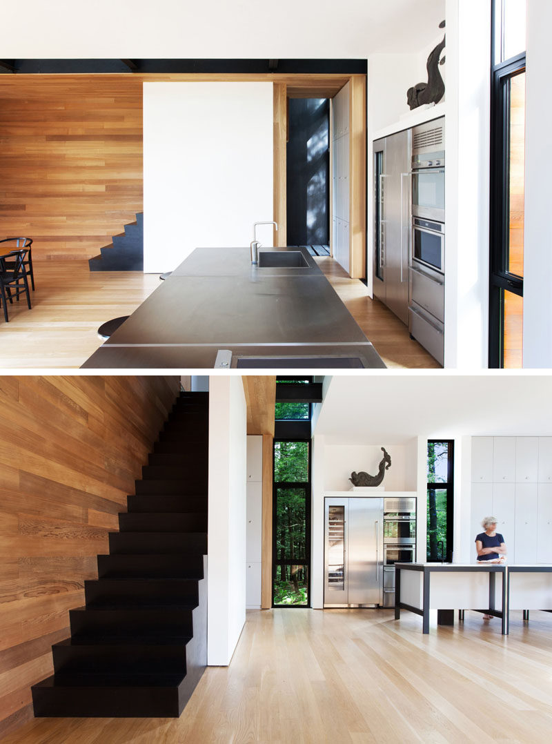 A simple kitchen is located near the dining room in this home, and black stairs lead you to the upper level.