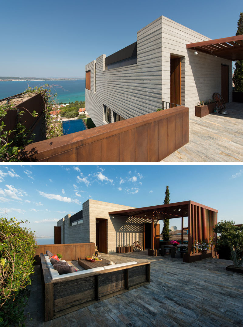 At the top of this home, there's an outdoor area with a covered dining space, and a lounge that takes advantage of the view.