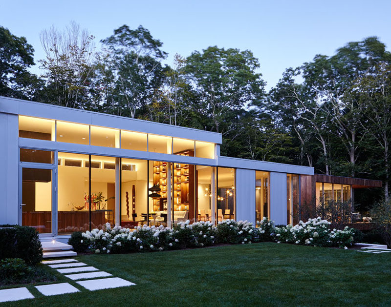 A landscaped yard with paths surrounds this New York home.