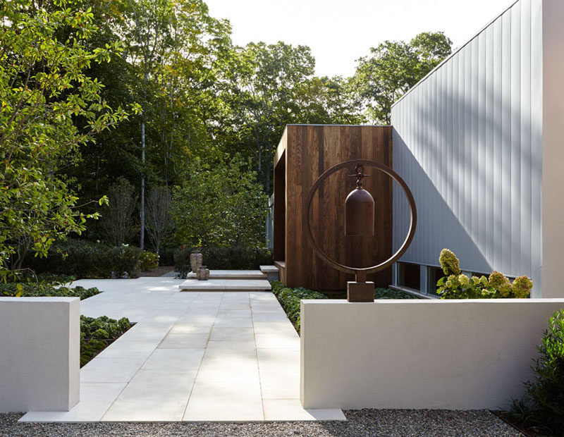 Leading up to this home, it's easy to see that the yard has been meticulously designed, with small steps leading up to the front door that's surrounded by wood.