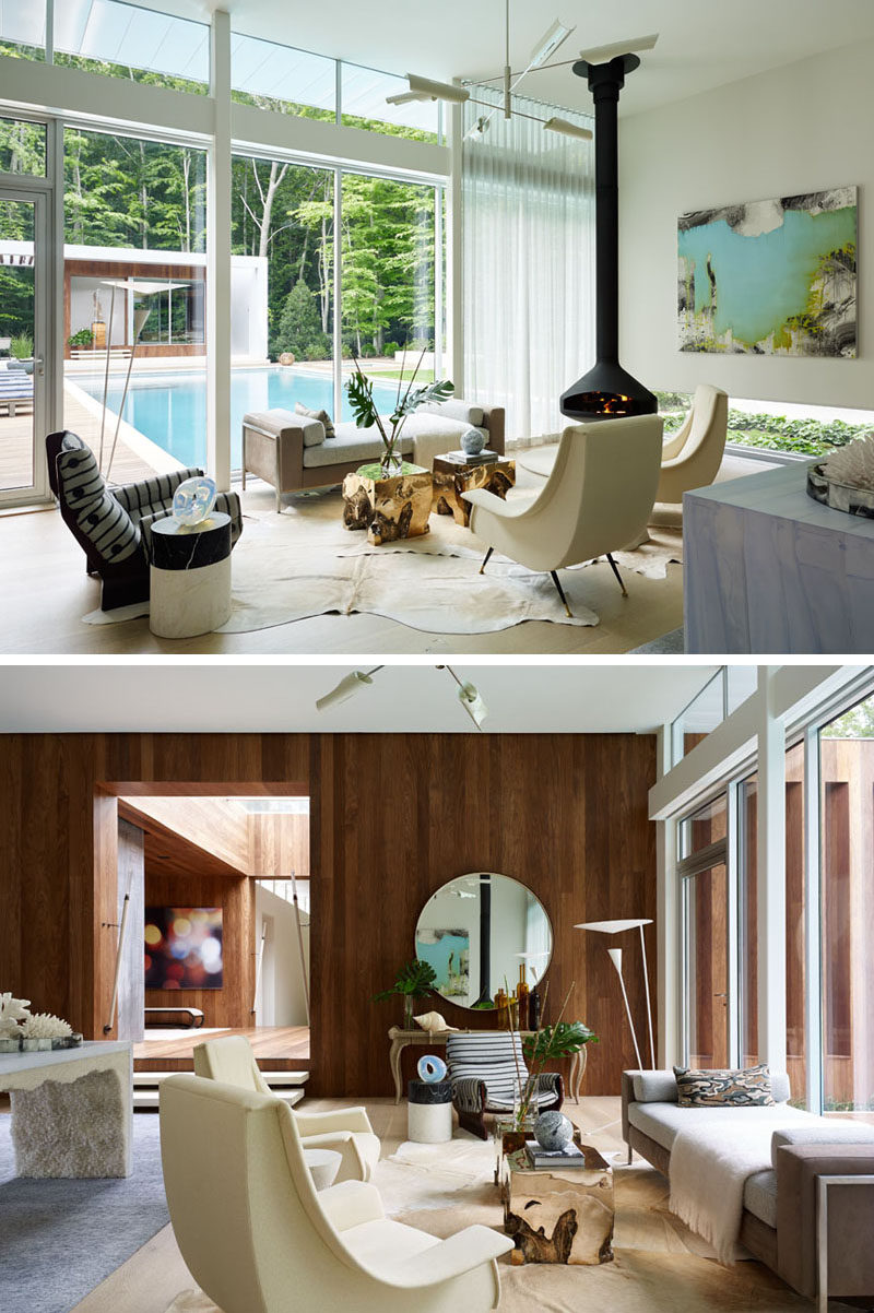 With views of the pool outside, this sitting area has a hanging fireplace to keep it warm on cool nights.