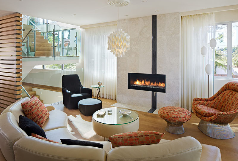 A curved sofa focused on the fireplace helps to define the living area.