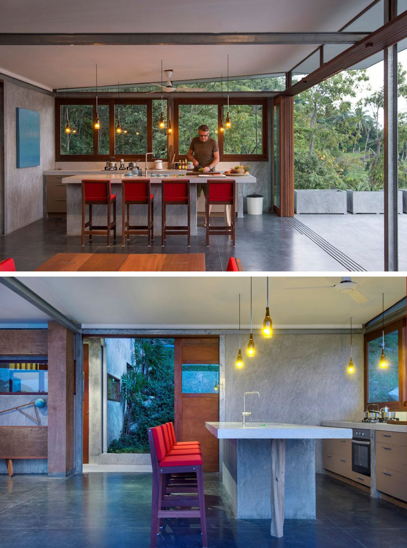 In this kitchen there's no overhead cupboards or tall fridge, keeping the space simple, and bottles have been transformed into pendant lights.