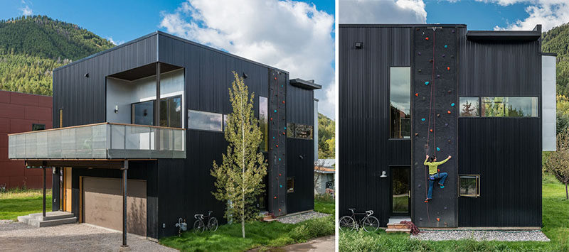 Black corrugated metal and a rock climbing wall cover the exterior of this home.