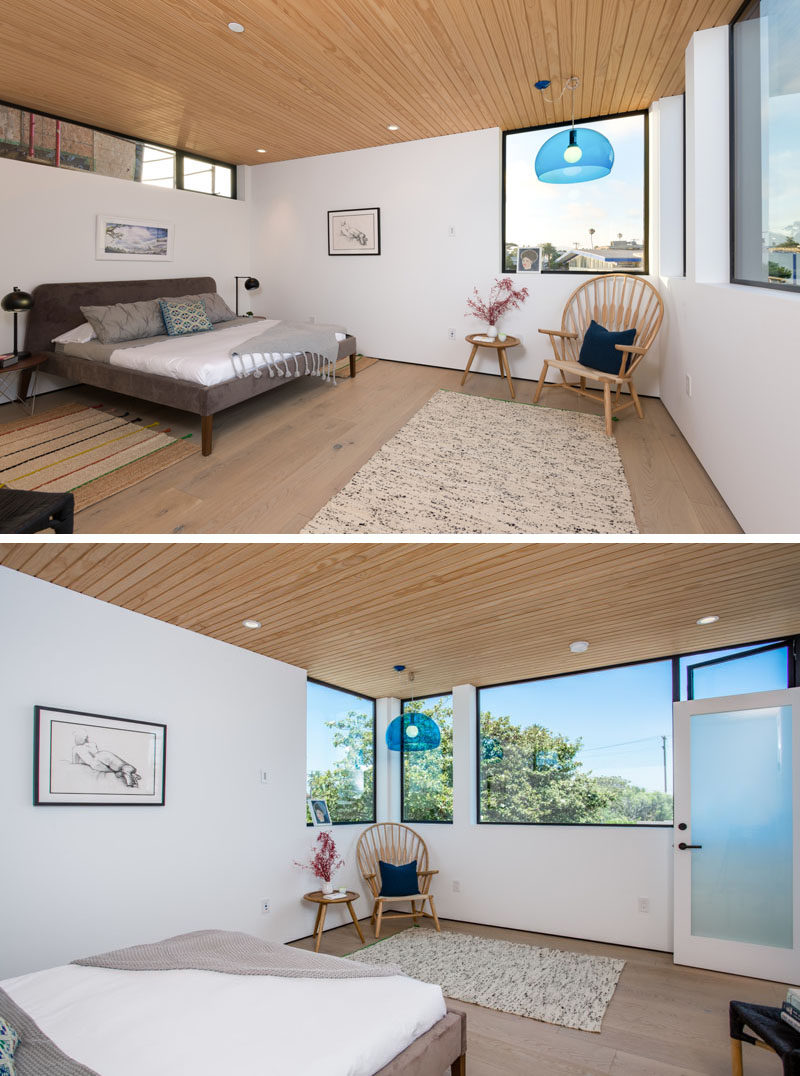 This bedroom has windows of various sizes allowing for plenty of natural light. White walls have been paired with a wooden ceiling and floor for a contemporary bedroom look.