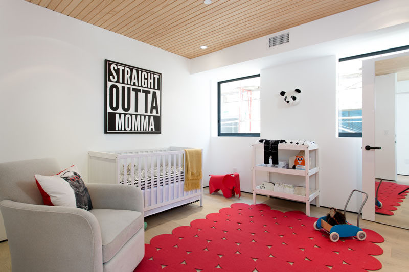 Pops of red paired with fun artwork make this nursery feel fun and colorful.