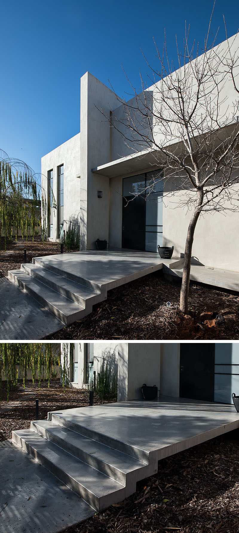 At the front of this home, tree bark covers the ground to enhance the concrete strip and stairs leading you to the front door.