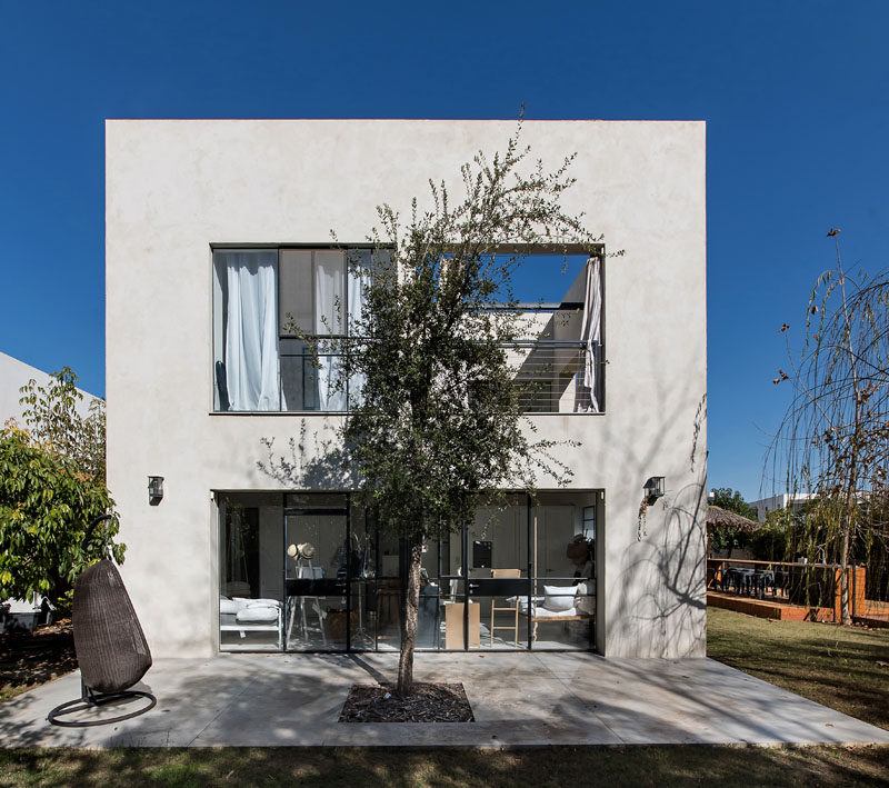 This home has a small patio area with a centrally located tree to provide shade.