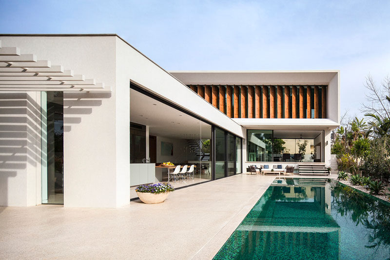 Paz Gersh Architects have designed this contemporary L-shaped home in Tel Aviv, Israel, for a family with children.