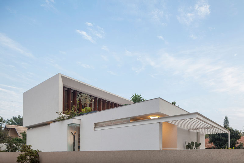 Paz Gersh Architects have designed this contemporary L-shaped home in Tel Aviv, Israel, for a family with children.