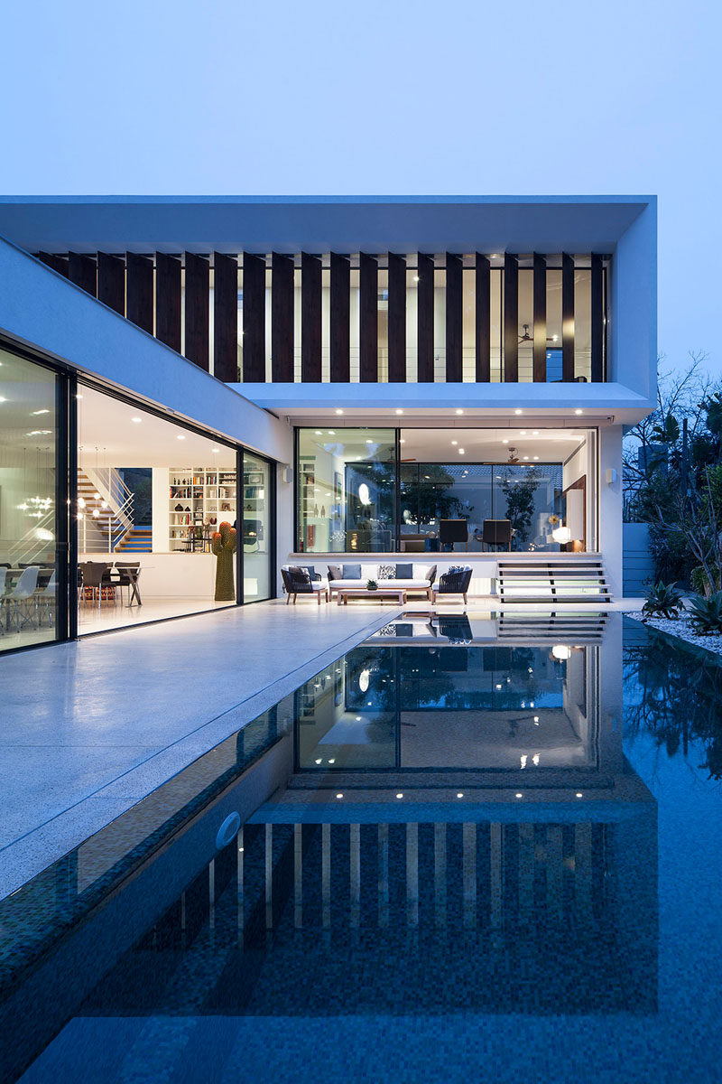 The swimming pool is the focal point of this home, and it's almost seamless in its integration, with it having no steps down to it from the kitchen and dining area.